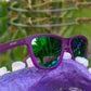 Óculos de sol Goodr Brasil com armação roxa fosca e lentes verdes espelhadas polarizadas, design quadrado esportivo.